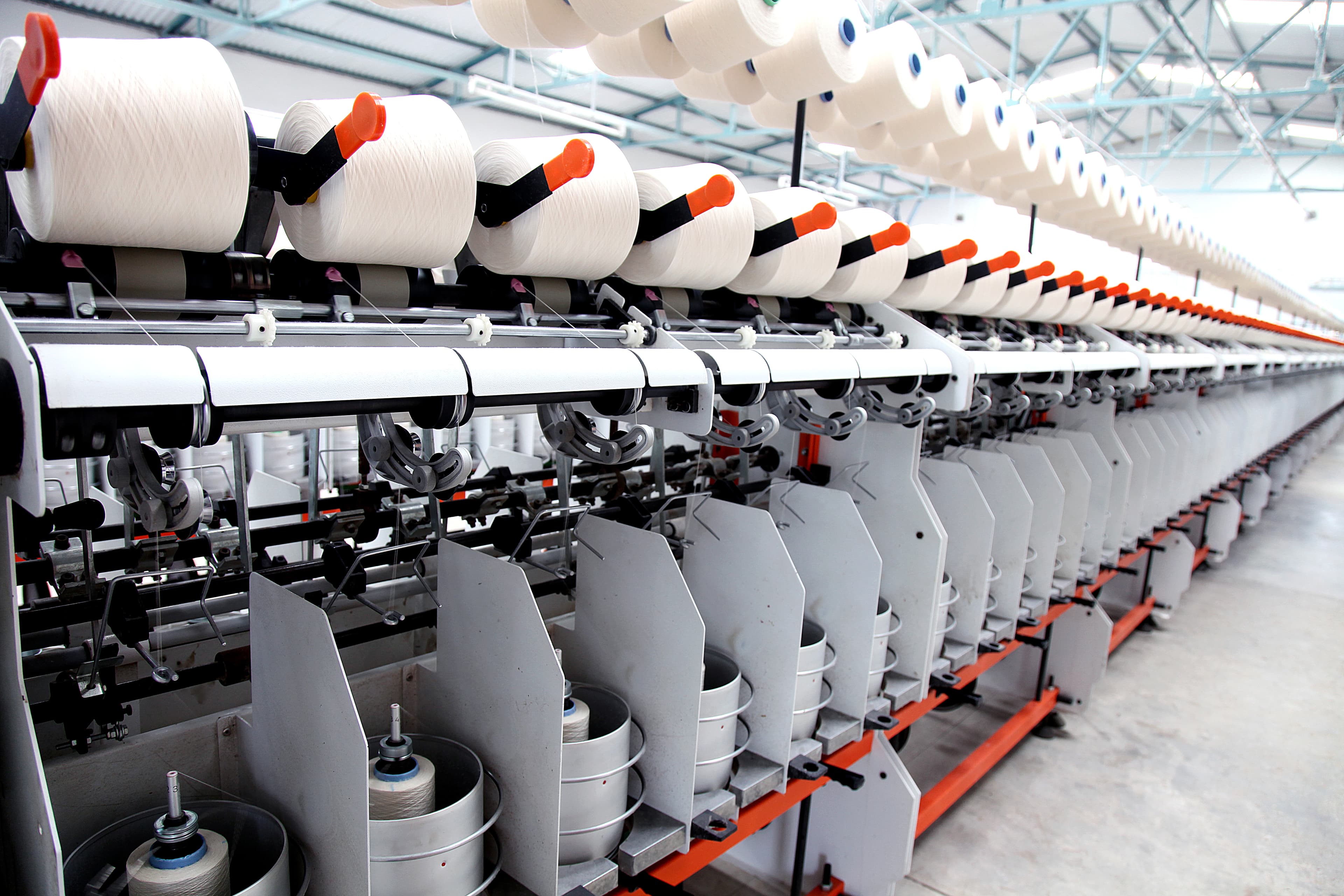 Shuttleless loom weaving fabric at Umed Group's weaving unit